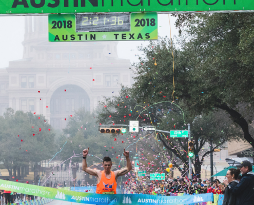 Joey Whelan crossing the 2018 Austin Marathon finish line.