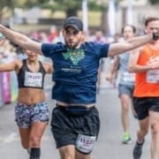 love-the-austin-marathon-feature Runner excitedly crosses the 2019 Austin Half Marathon finish line. Run Austin, the #1 city in America and you will understand why people love the Austin Marathon!