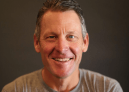 Smiling middle-aged man against dark background