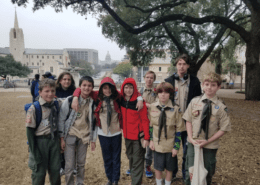 Group of Boy Scouts posing outdoors under tree