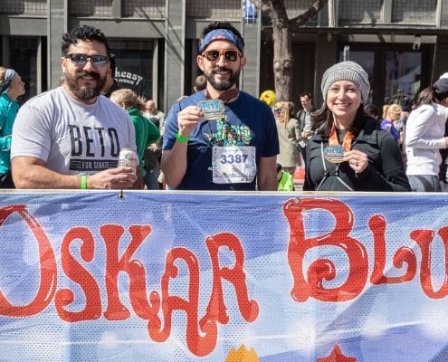 Runners celebrate at the Oskar Blues Brewery beer garden after completing the 2019 Austin Marathon.