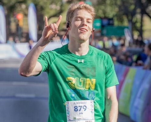 Runner crosses the 2019 Austin Marathon finish line. Download the free marathon training plan and you can cross the 2020 Austin Marathon finish line!