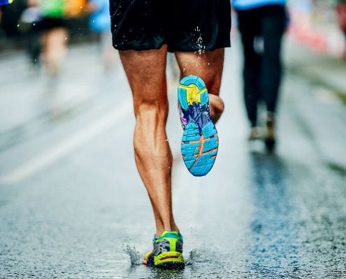 Image of a runner running on the road. Rene Arquello is dedicating his first marathon, the Austin Marathon, to his wife Veronica!