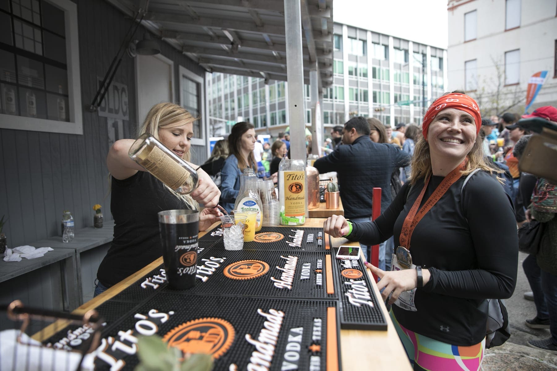 Image of a bartender pouring a drink with Tito's Handmade Vodka at the 2019 Austin Marathon beer garden.