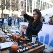 titos-handmade-vodka-feature Image of a bartender pouring a drink with Tito's Handmade Vodka at the 2019 Austin Marathon Hilton VIP Experience.