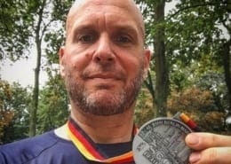 Image of Jonathan Acott showing off his medal from the Berlin Marathon. Read about his journey to run the world and how the Austin Marathon is next!