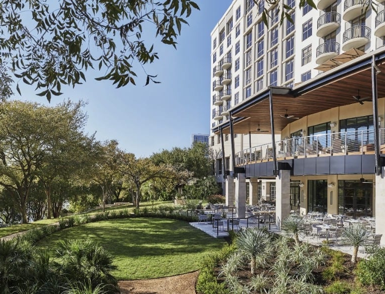 Image of Four Seasons Hotel Austin overlooking Lady Bird Lake. Book a luxury hotel and make your Austin Marathon weekend that much more memorable. More information at https://youraustinmarathon.com/austin-luxury-hotels/