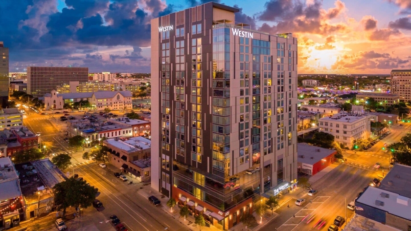 Image of The Westin Austin Downtown hotel with the sunset in the background, credit Westin Austin. Book a luxury hotel and make your Austin Marathon weekend that much more memorable. More information at https://youraustinmarathon.com/austin-luxury-hotels/