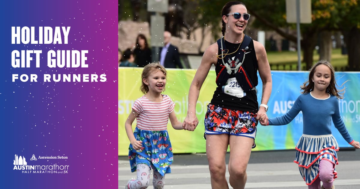 Image of a mom running towards the Austin Marathon finish line with her two children. Text on design reads 2020 Holiday Gift Guide. Learn more at http://48d.435.myftpupload.com/2020-holiday-gift-guide/