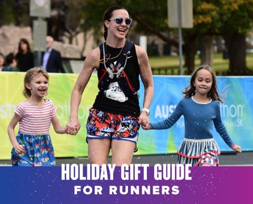 Image of a mom running towards the Austin Marathon finish line with her two children. Text on design reads 2020 Holiday Gift Guide. Learn more at http://48d.435.myftpupload.com/2020-holiday-gift-guide/
