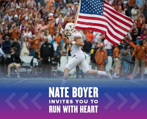 Nate Boyer leads the Texas Longhorns onto the field carrying the American flag. Text on design reads Nate Boyer Invites You to Run with Heart. Learn more at http://48d.435.myftpupload.com/join-nate-boyer-run-with-heart/