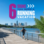 1121392_AustinMarathon2022-6-SignsYouNeedRunningVacation_Feature_070921 A runner jogs on the trail around Town Lake with the Austin skyline in the background. Text on design reads 6 Signs You Need a Running Vacation. Read more about why you need a runcation at http://48d.435.myftpupload.com/you-need-a-runcation/