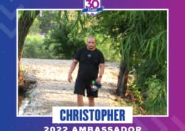 Person walking through shallow creek under trees
