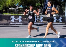 Two women excitedly run towards the finish of the Austin Marathon.
