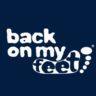 The image shows the logo for "Back on My Feet," with the words written in white, stylized text on a dark blue background. The word "feet" is integrated within an abstract footprint design with toes represented by dots, emphasizing the charity’s involvement with "Austin Gives Miles. Austin Marathon Half Marathon & 5K