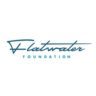 Logo of the Flatwater Foundation, featuring the organization's name in a stylized, cursive blue font with a flatwater icon to the left. The word "FOUNDATION" is in uppercase letters below the main script. The overall design is simple and clean, embodying the essence of Austin Gives Miles charities. Austin Marathon Half Marathon & 5K