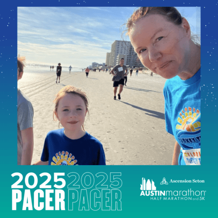 A woman and a child wearing matching blue race T-shirts smile at the camera while standing on a beach during a running event. Other runners are seen in the background. The image has a graphic overlay indicating "Meet 2025 PACER" and the logos for the Ascension Seton Austin Marathon. Austin Marathon Half Marathon & 5K