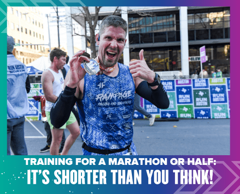 A runner joyfully holds up a medal at a marathon event, proudly donning a blue tank top. The text proclaims, "Marathon Training or Half: It's Shorter Than You Think!" Colorful banners and vibrant buildings create an uplifting backdrop. Austin Marathon Half Marathon & 5K