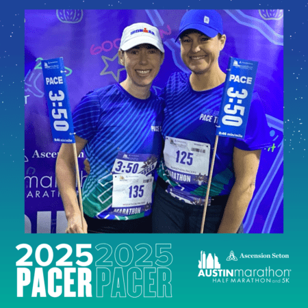 Two smiling women, both pacers for the Austin Marathon, wear blue and purple gear as they pose together. They hold pace flags reading "3:50." Behind them is a blue backdrop with "Austin Marathon" branding and the year 2025 prominently displayed. Austin Marathon Half Marathon & 5K