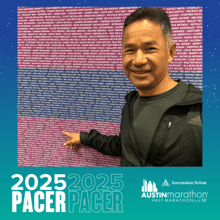 A man points to a name on a wall filled with many names in white and pink text, highlighting the Pacer Group for the 2025 Austin Marathon, Half Marathon, and 5K. The wall is part of a promotional display against a gradient background of blue to teal. Austin Marathon Half Marathon & 5K