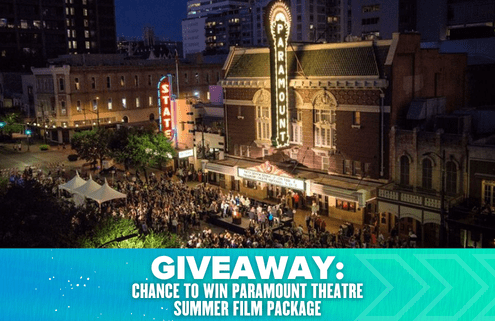 Aerial view of a crowd gathered outside the illuminated Paramount Theatre at night. Text overlay reads: "Giveaway: Win a Paramount Theatre Summer Film Package. Austin Marathon Half Marathon & 5K