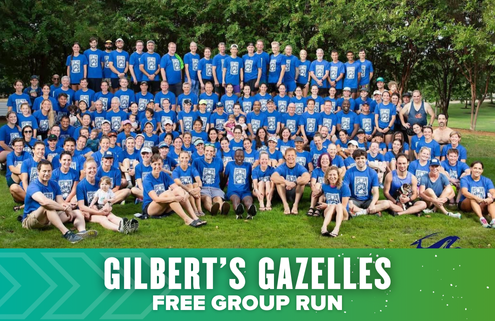A large group of people wearing matching blue Gilbert’s Gazelles shirts pose outdoors on grass, smiling for a group photo. Text at the bottom reads "Gilbert’s Gazelles Free Group Run" celebrating Launch week with the Austin Marathon community. Austin Marathon Half Marathon & 5K