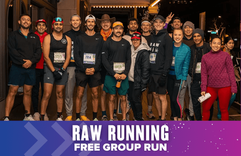 A group of runners in athletic gear pose together and smile for a photo at night. A banner at the bottom reads “RAW Running Free Group Run” in bold white letters, highlighting their energetic group run experience. Austin Marathon Half Marathon & 5K