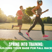 Pair of runners training on sunny park path