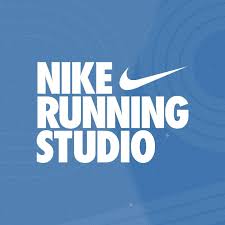 White bold text on a blue background reads "NIKE RUNNING STUDIO" with the Nike swoosh logo above "RUNNING." Subtle circular patterns decorate the background, evoking the spirit of Austin running groups and local marathon training. Austin Marathon Half Marathon & 5K