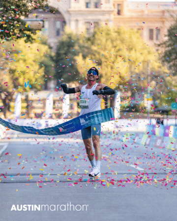 A runner celebrates as he crosses the finish line at the Austin Marathon race, surrounded by colorful confetti and sunlight, with "AUSTIN marathon" text and an Official Race Photos watermark at the bottom of the image. Austin Marathon Half Marathon & 5K