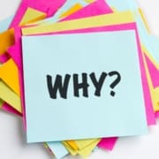 A stack of colorful paper sheets with a blue sheet on top that has "WHY?" in bold black letters—perfect inspiration for any beginner runner creating their runner checklist or starting their journey running for beginners. Austin Marathon Half Marathon & 5K