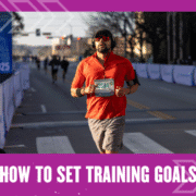 A man wearing a red shirt, shorts, and sunglasses runs a race on a city street, with a race bib pinned to his shirt. The text below reads, "How to Set Training Goals" on a purple border—perfect inspiration to set training goals of your own. Austin Marathon Half Marathon & 5K