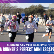 Two smiling runners, one giving a thumbs up, participate in a road race with others on a sunny day. The text reads, “Summer Day Trip Austin: A Runner Mini Escape—your perfect break in the heart of the city.”. Austin Marathon Half Marathon & 5K