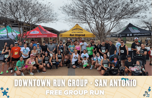A large group of runners pose together outdoors under tents at a park for a Downtown Run Group event in San Antonio. The text reads “Downtown Run Group · San Antonio. Free group run open to all.”. Austin Marathon Half Marathon & 5K