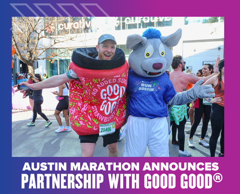 Two people at the Austin Marathon: one is dressed as a jar of GOOD GOOD strawberry jam, the other as a wolf mascot in an “Austin Marathon” shirt. Both are smiling with arms outstretched, celebrating the Ascension Seton partnership announcement. Austin Marathon Half Marathon & 5K