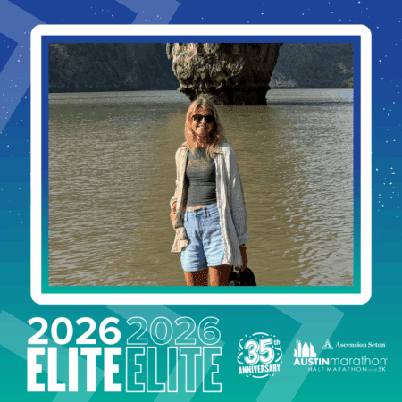 A woman wearing sunglasses, a striped shirt, and denim shorts stands in shallow water with a rocky cliff in the background. The turquoise border highlights