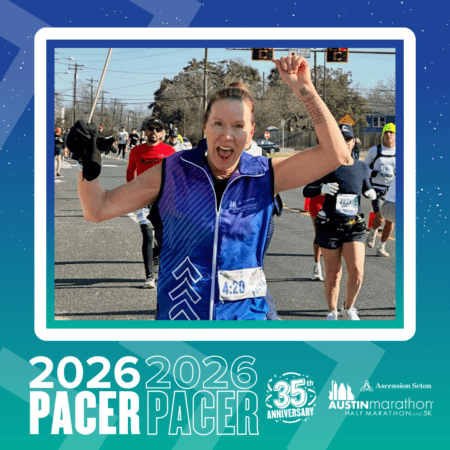 A smiling runner in a blue vest with