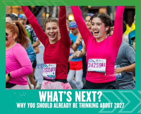 Two women in pink tops, smiling and raising their arms as they run a race, surrounded by other runners. Text below reads, "WHAT'S NEXT? Why strategic planning for 2027 should already be on your radar. Austin Marathon Half Marathon & 5K
