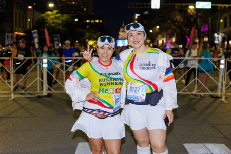 Two runners in colorful jerseys at night race Two runners in colorful jerseys at night race