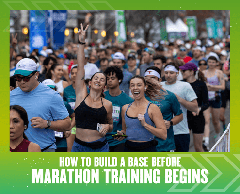 Crowd of runners at a race, two women in front smiling and making peace signs, surrounded by other participants. Text reads: "How to Build a Base Before Marathon Training Begins." Green graphic border emphasizes base building for running success. Austin Marathon Half Marathon & 5K