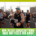 A group of runners participates in a race on a city street, with sunlight and tall buildings in the background. Text at the bottom reads, "How to stay consistent with training when race day feels far away. Austin Marathon Half Marathon & 5K