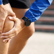 Runner clutching knee in pain