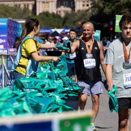 Runner receiving finisher bag at race finish