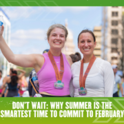 Two smiling women wearing medals and athletic attire hold water bottles after a race, standing outdoors on a sunny day. Text below reads: “Don’t wait: Why summer is the smartest time to commit to February.”. Austin Marathon Half Marathon & 5K