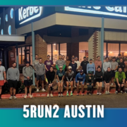 About 30 people stand in front of a café at night, gathered for a group photo during KickOff Week. The text “5RUN2 AUSTIN” is at the bottom. The café sign and running attire suggest this is a group run with Cafecito Run Club, highlighting their strong sense of community. Austin Marathon Half Marathon & 5K