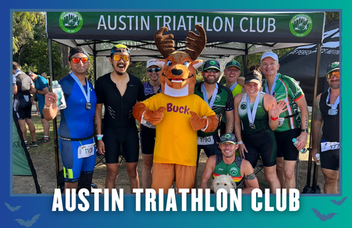 A group of smiling athletes, some in cycling gear and medals, pose with a person in a moose mascot costume under an “Austin Triathlon Club” tent—celebrating after an energetic South Austin Group Run. Blue border with white text. Austin Marathon Half Marathon & 5K