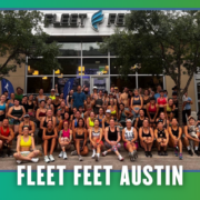 A large group of people in athletic wear poses and smiles outside the Fleet Feet Austin store, surrounded by trees, with “Fleet Feet Austin” text at the bottom, capturing the lively spirit of a South Austin Group Run. Austin Marathon Half Marathon & 5K
