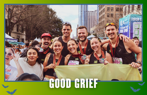 A group of smiling marathon runners with medals pose together outdoors in a city, holding a yellow banner for their KickOff Week. Text at the bottom reads “GOOD GRIEF.” Buildings and trees are visible in the background. Austin Marathon Half Marathon & 5K