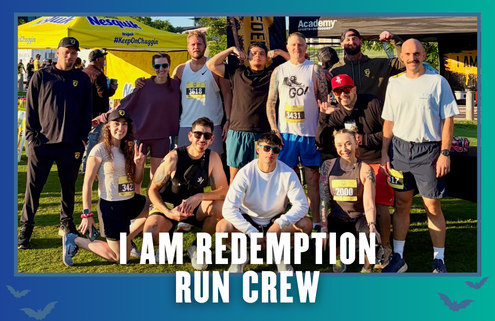A group of 13 smiling runners in athletic gear pose together outdoors after a race in South Austin. Some wear medals and bib numbers, celebrating their accomplishment. The words “I AM REDEMPTION RUN CREW” are displayed at the bottom, capturing the spirit of this vibrant Group Run. Austin Marathon Half Marathon & 5K