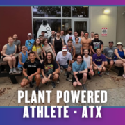 A group of people poses together on and around picnic benches outside a building, celebrating KickOff Week. The text at the bottom reads, “Plant Powered Athlete - ATX.” The border is purple and blue with small bat icons. Austin Marathon Half Marathon & 5K